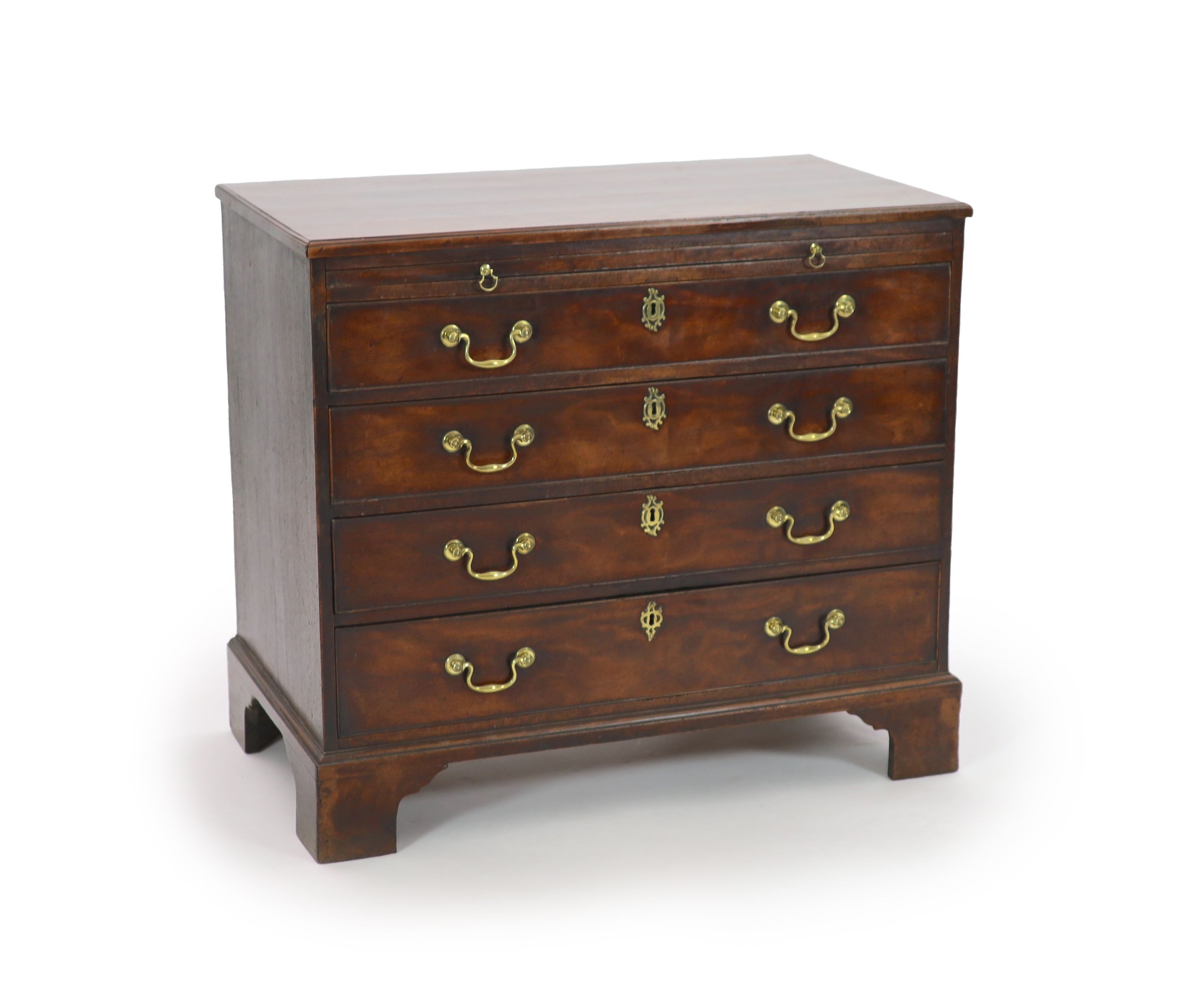 A George III mahogany chest of four graduated long drawers with brushing slide W 93cm D 52cm. H 83cm.